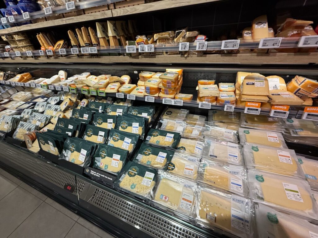 Cheese section in an Austrian supermarket featuring a variety of local and European cheeses