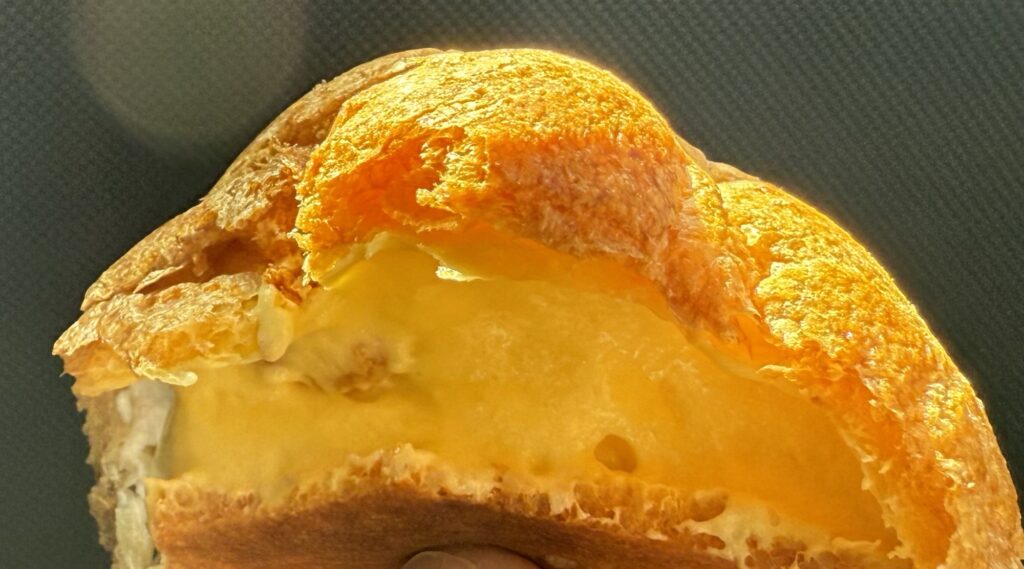 カスタードクリームが入ったシュークリームの断面写真